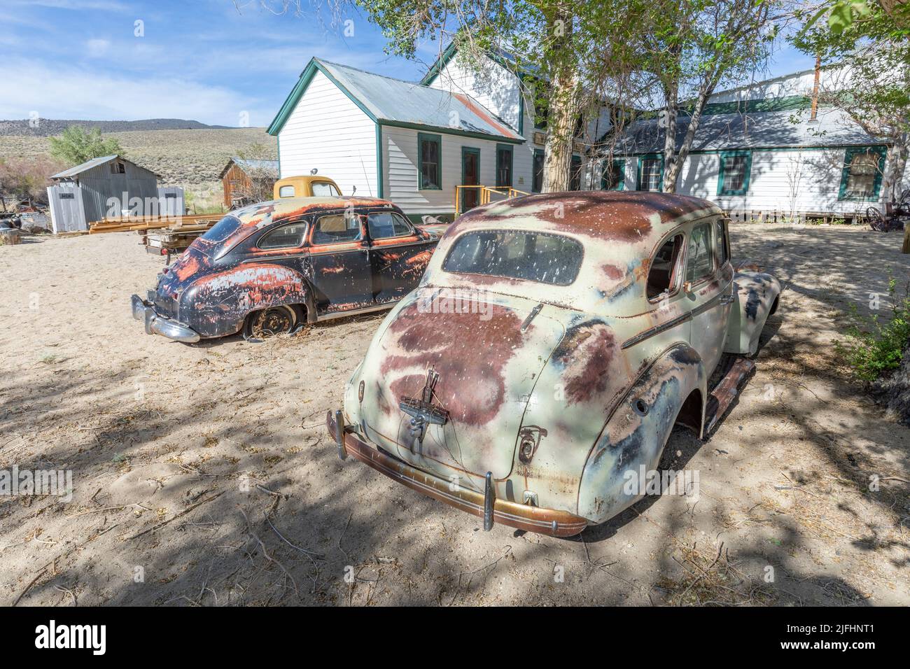 Benton hot Springs, USA - June 3, 2022: old vintage rusty car wrecks at an old abandoned farm in USA Stock Photo