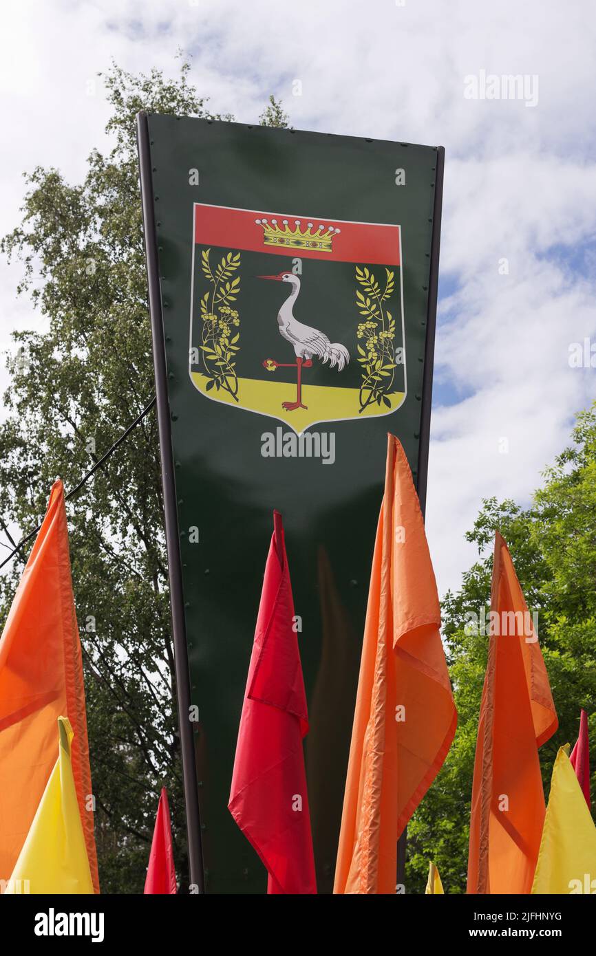 Coat of arms (A silver crane holds a golden stone in a paw) on Leningradskaya Street of the municipality settlement Pesochny in Kurortny District in S Stock Photo