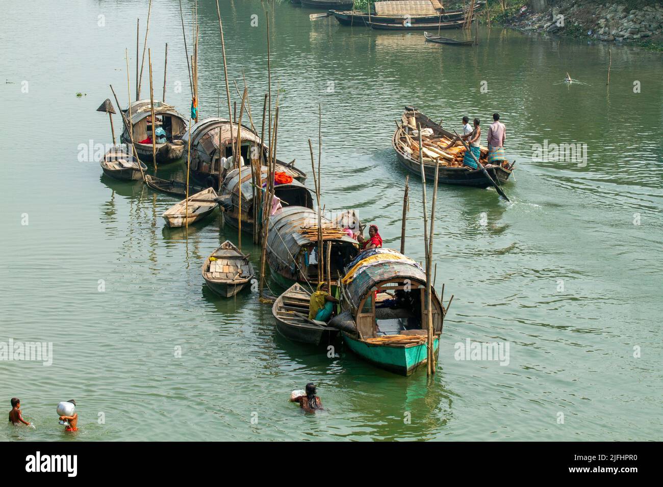 A row of narrowboats belonging to gypsies moored at a canal near Meghna River at Sahapur in Sonargaon, Narayanganj, Bangladesh. Stock Photo