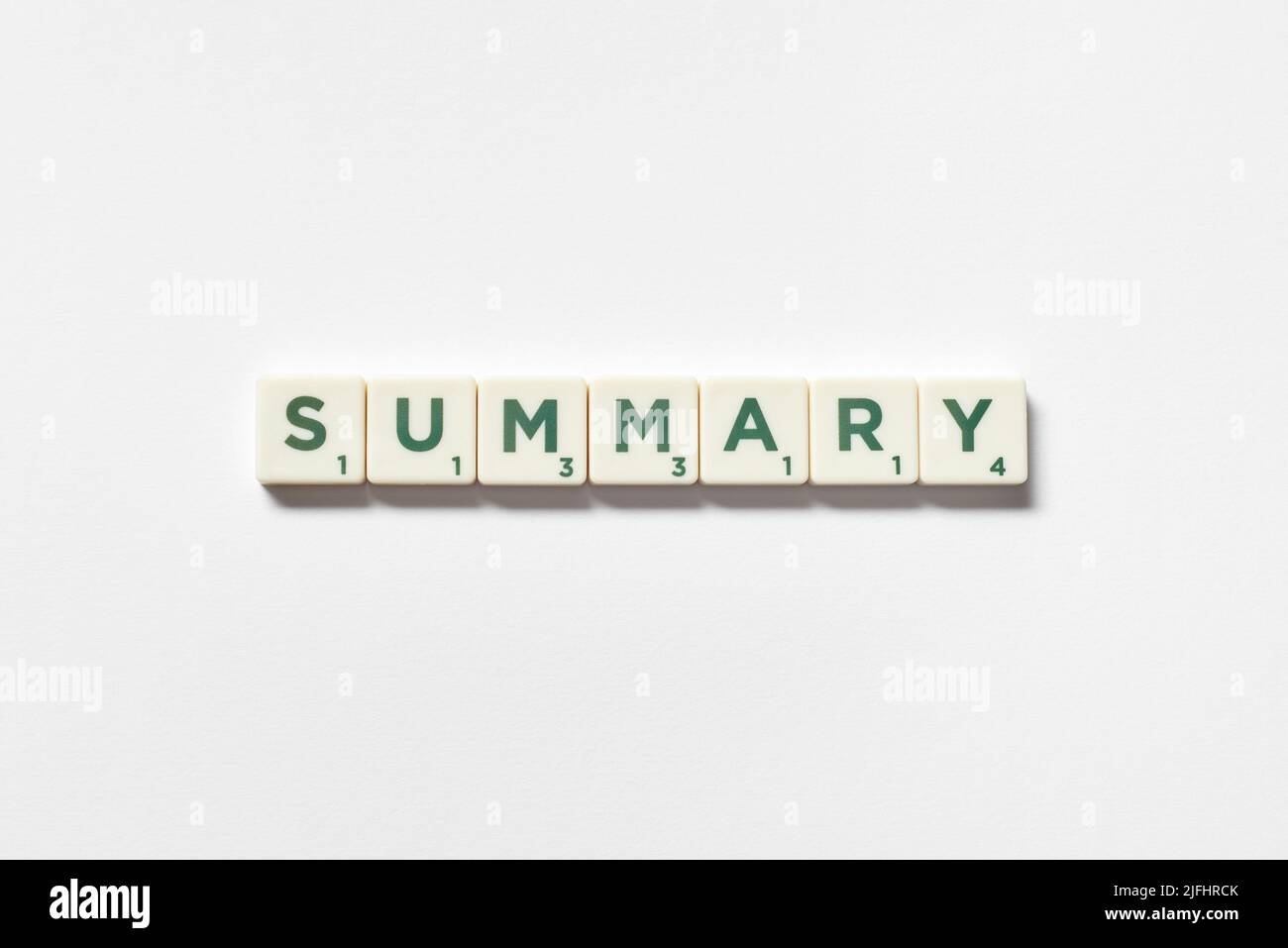 Summary formed of scrabble blocks on white background. Stock Photo