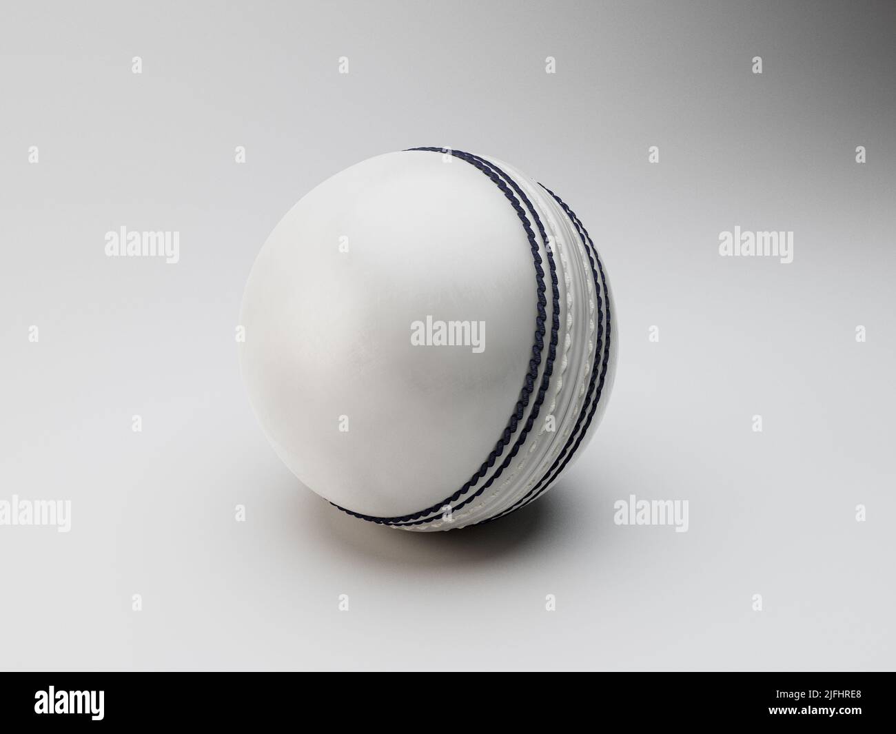 A regular white cricket ball with navy stitching on an isolated