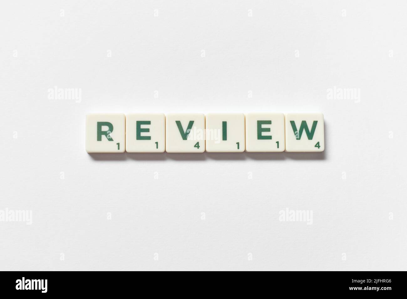 Review formed of scrabble elements on white background. Stock Photo