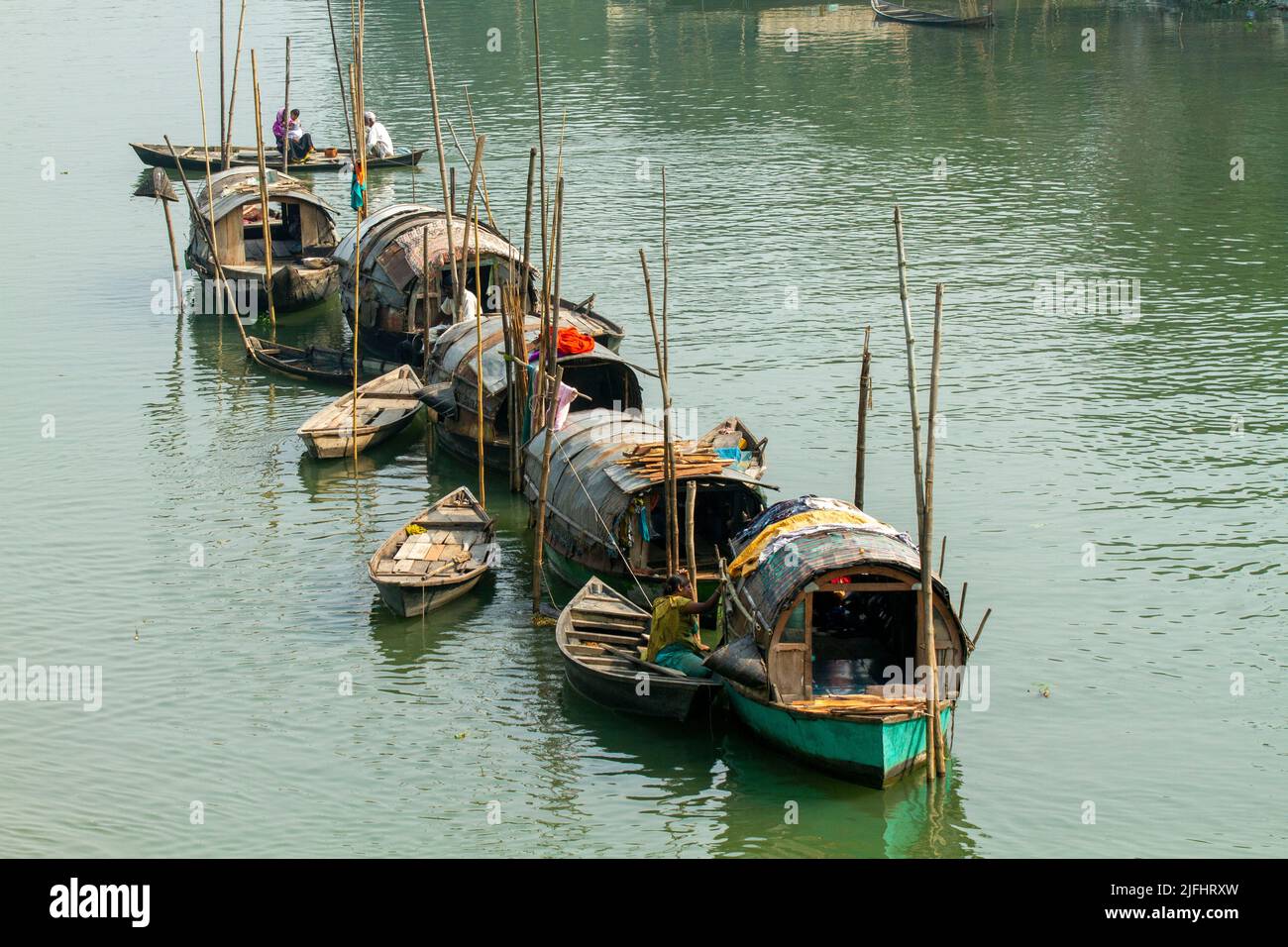 A row of narrowboats belonging to gypsies moored at a canal near Meghna River at Sahapur in Sonargaon, Narayanganj, Bangladesh. Stock Photo