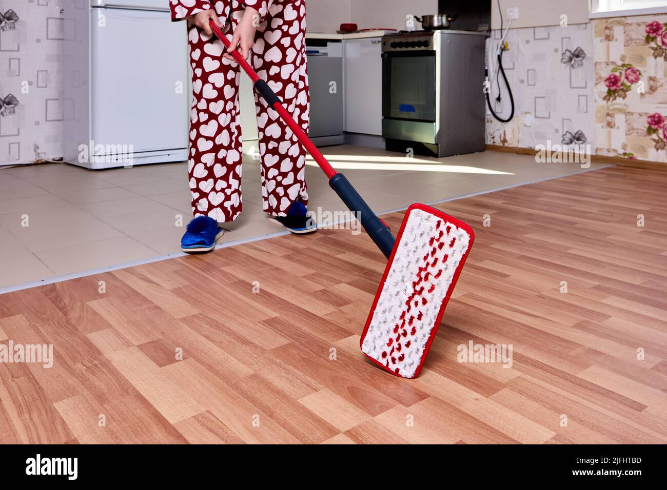 Using flat mop with microfiber pad to mopping floor in kitchen during housework Stock Photo Alamy