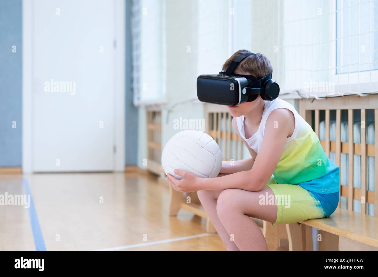School kid with interactive glasses playing volleyball in a physical