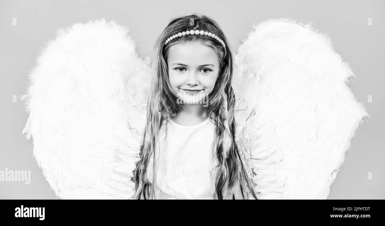 Valentines Day. Portrait of beautiful angel little girl with angels wings. Happy little Angel. Beautiful young girl wearing angel wings Stock Photo