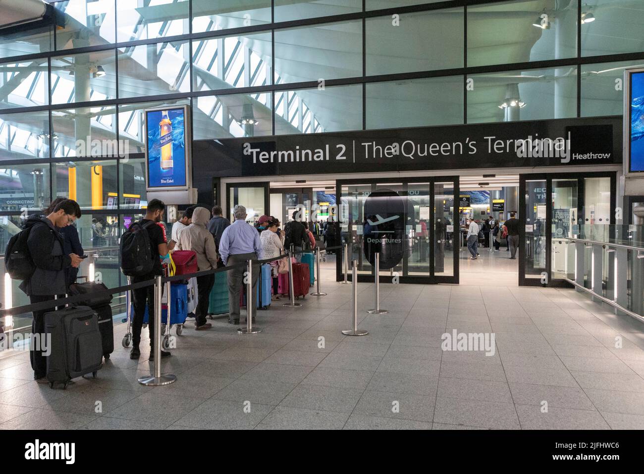 Having packed up the departure hall at London Heathrow Terminal 2, flyers queue outside the terminal.  Image shot on 25th June 2022.  © Belinda Jiao Stock Photo