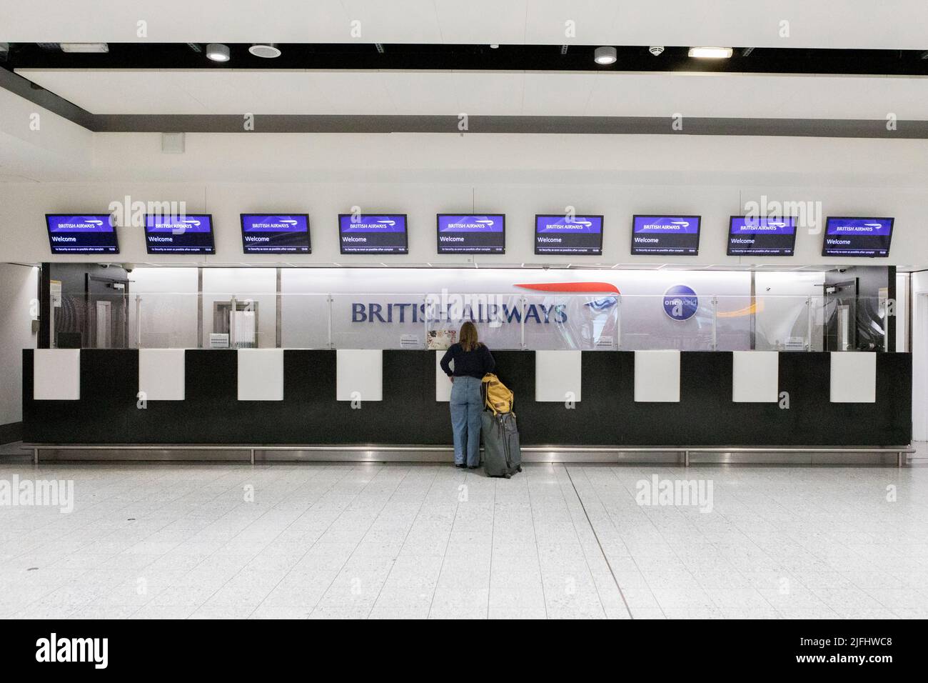 A woman inquires at a near-empty British Airways counter at London Heathrow Terminal 3.  Image shot on 25th June 2022.  © Belinda Jiao   jiao.bilin@gm Stock Photo