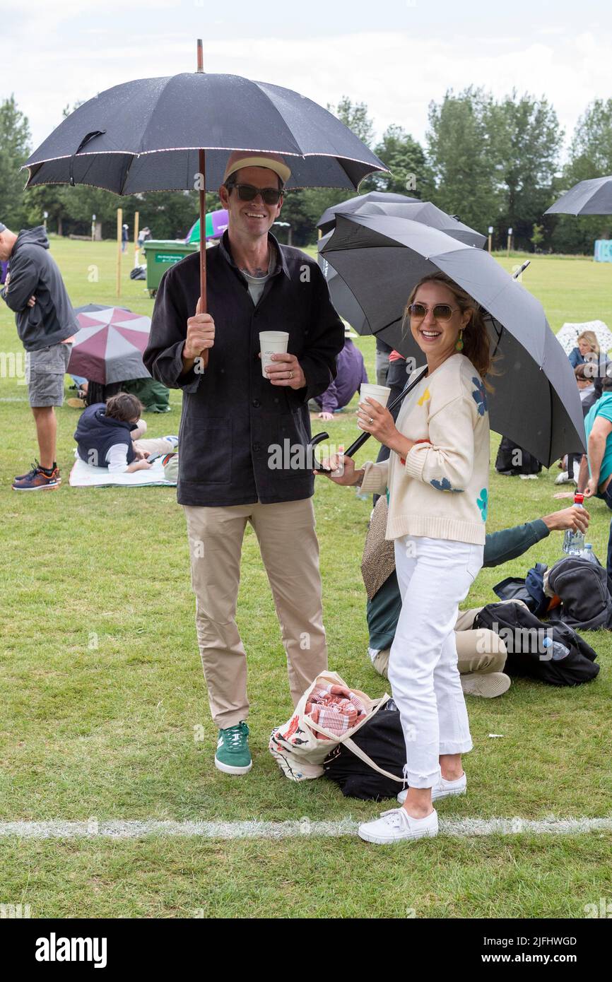 Tennis fans brace rain while queuing at Wimbledon Park ahead of the 2022 Championship.   Image shot on 27th June 2022.  © Belinda Jiao   jiao.bilin@gm Stock Photo