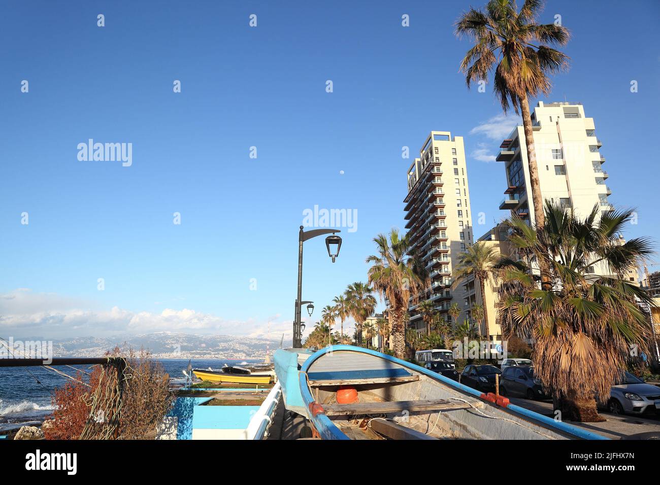 Beirut Corniche on a clear sunny day. During winter storms, fisherman bring up their boats from the small harbor to protect them from the elements. Stock Photo