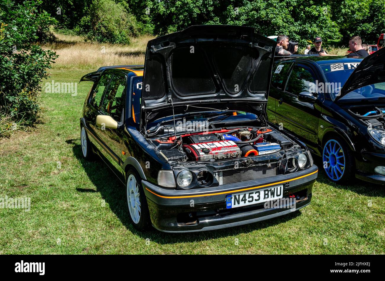 Front view of a 1995 Peugeot 106 in black converted into a rally car ...