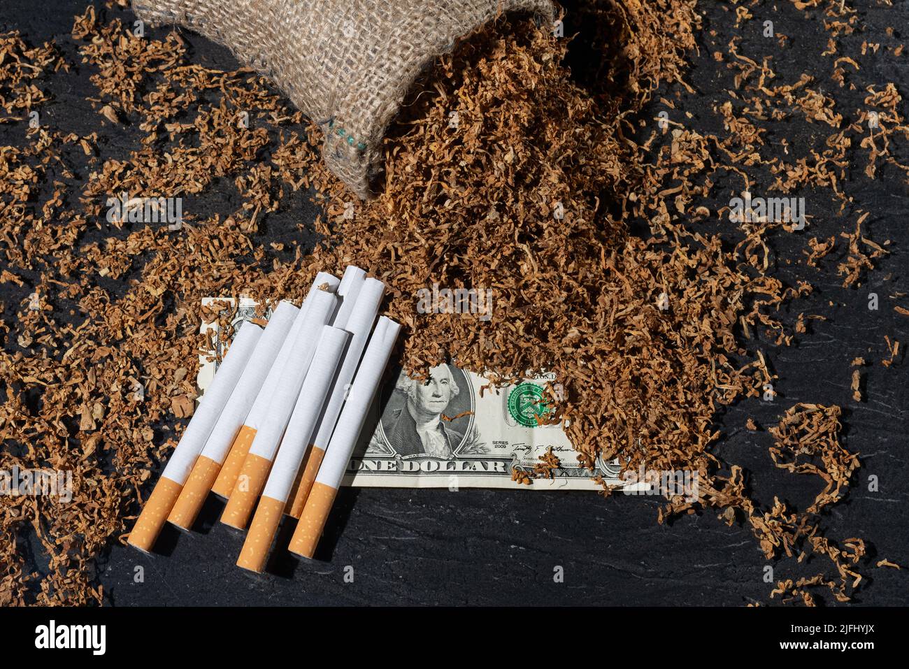 Dry smoking tobacco and cigarettes on a dollar bill Stock Photo Alamy
