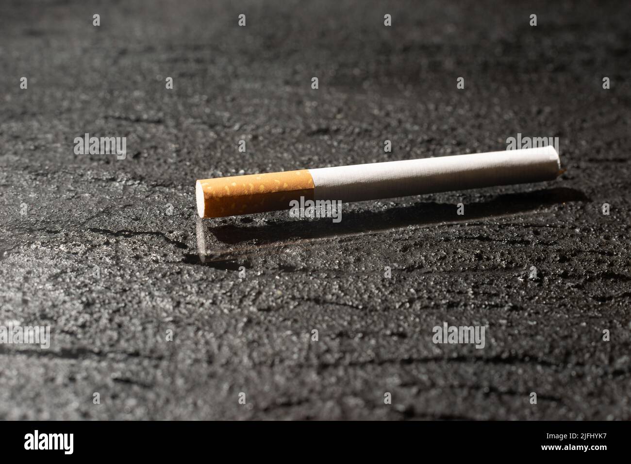 Cigarette on a dark concrete background. Smoking Stock Photo Alamy
