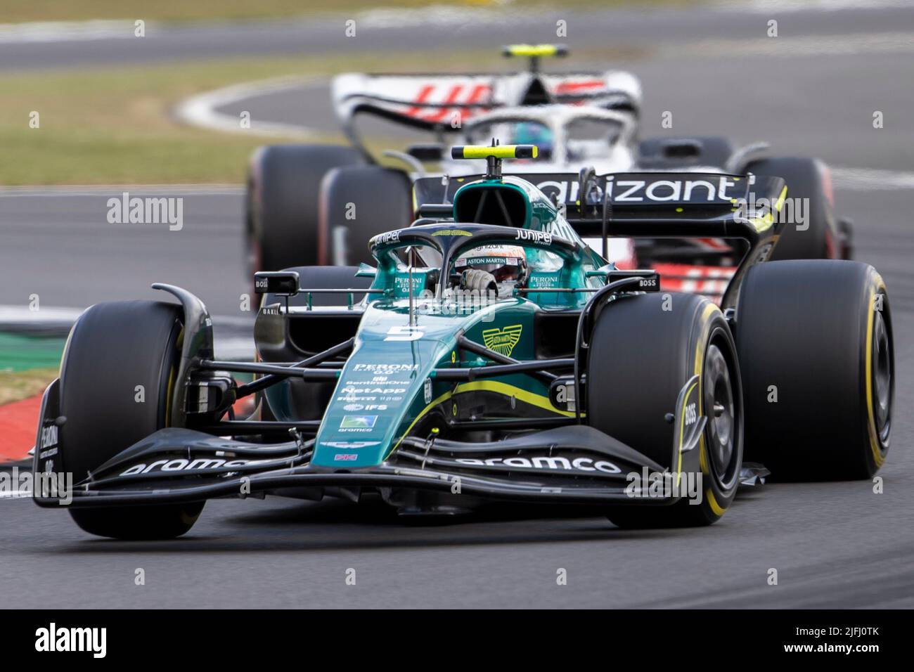 Silverstone, UK. 3rd July 2022, Silverstone Circuit, Silverstone, Northamptonshire, England: British F1 Grand Prix, Race day: Aston Martin Aramco Cognizant F1 Team driver Sebastian Vettel in his Aston Martin Aramco-Mercedes AMR22 leads from Haas F1 Team driver Mick Schumacher in his Haas-Ferrari VF-22 Credit: Action Plus Sports Images/Alamy Live News Stock Photo