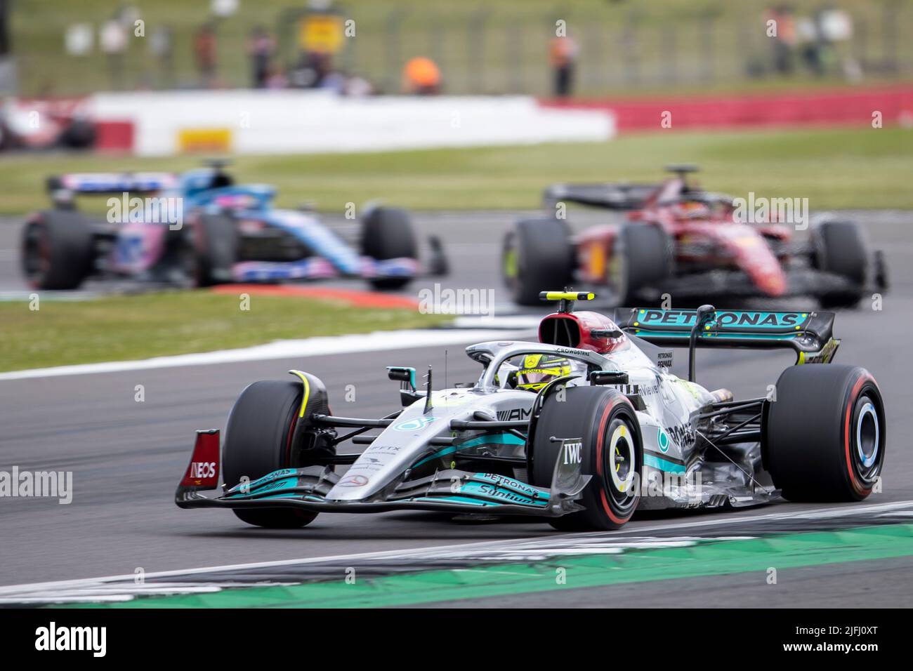 Silverstone, UK. 3rd July 2022, Silverstone Circuit, Silverstone, Northamptonshire, England: British F1 Grand Prix, Race day: Mercedes-AMG Petronas F1 Team driver Lewis Hamilton in his Mercedes F1 W13 leads the pack Credit: Action Plus Sports Images/Alamy Live News Stock Photo