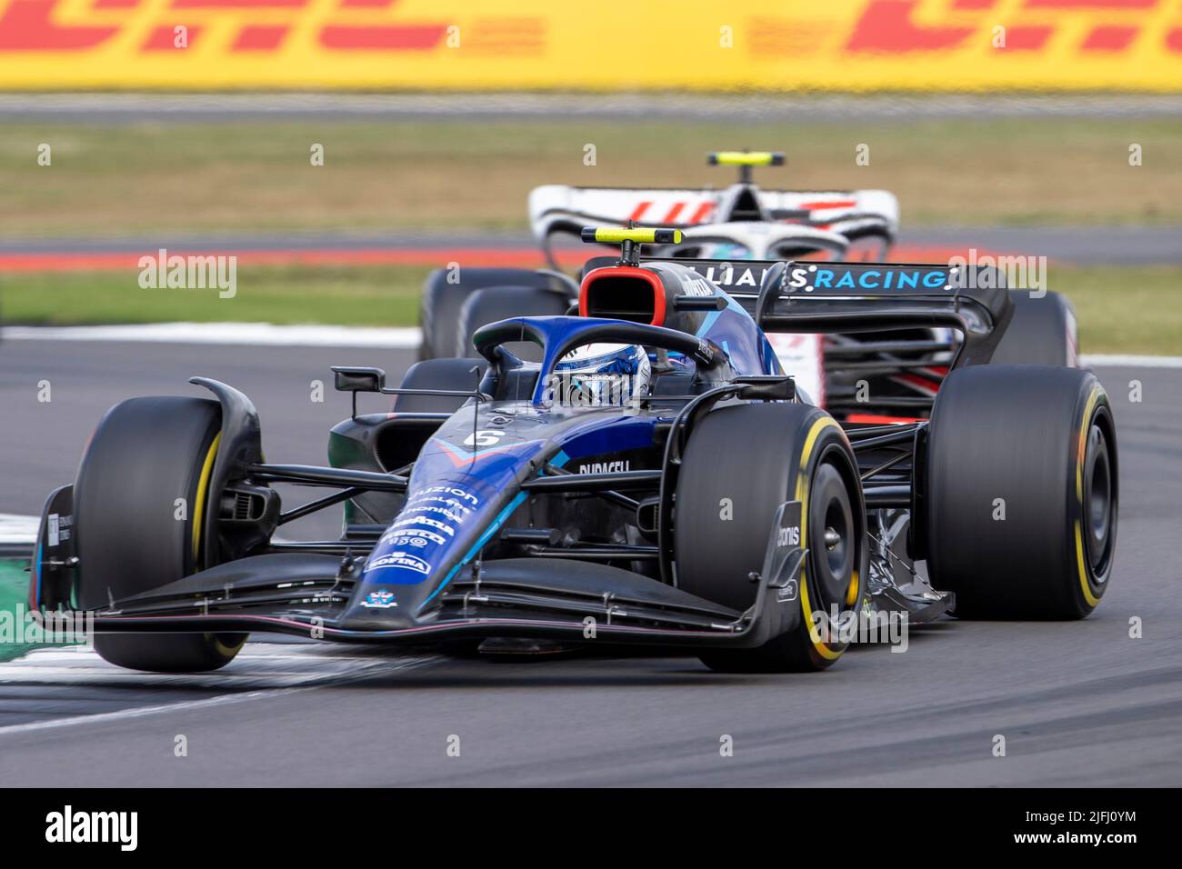 Silverstone, UK. 3rd July 2022, Silverstone Circuit, Silverstone, Northamptonshire, England: British F1 Grand Prix, Race day: Williams Racing driver Nicholas Latifi in his Williams-Mercedes FW44 ahead of Haas F1 Team driver Kevin Magnussen in his Haas-Ferrari VF-22 Credit: Action Plus Sports Images/Alamy Live News Stock Photo