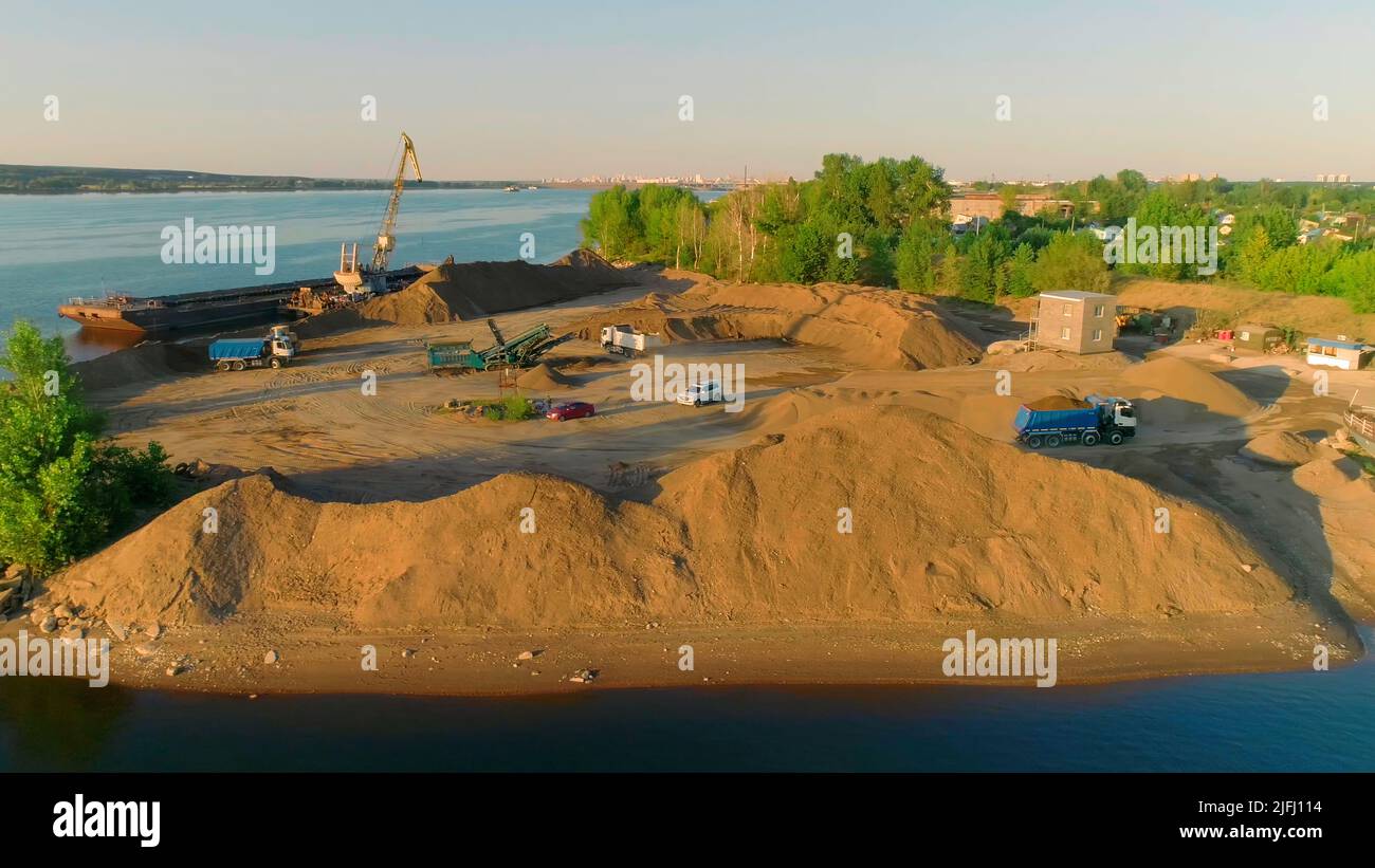 Excavator and heavy transport cleans beach. Scene. Clearing or