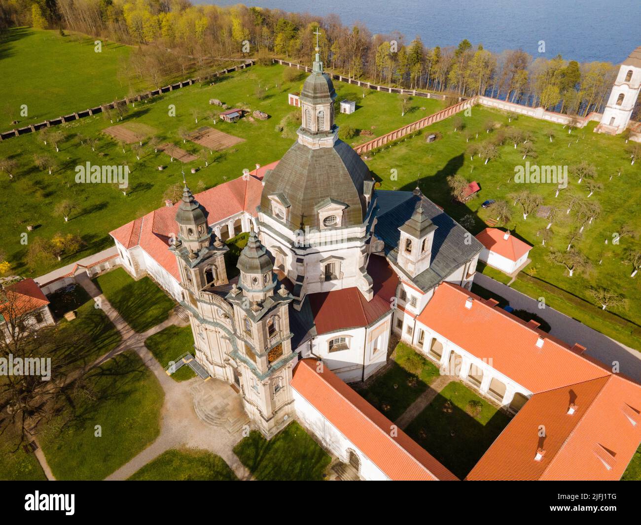 An aerial view of Pasaislis monastery surrounded by growing trees and
