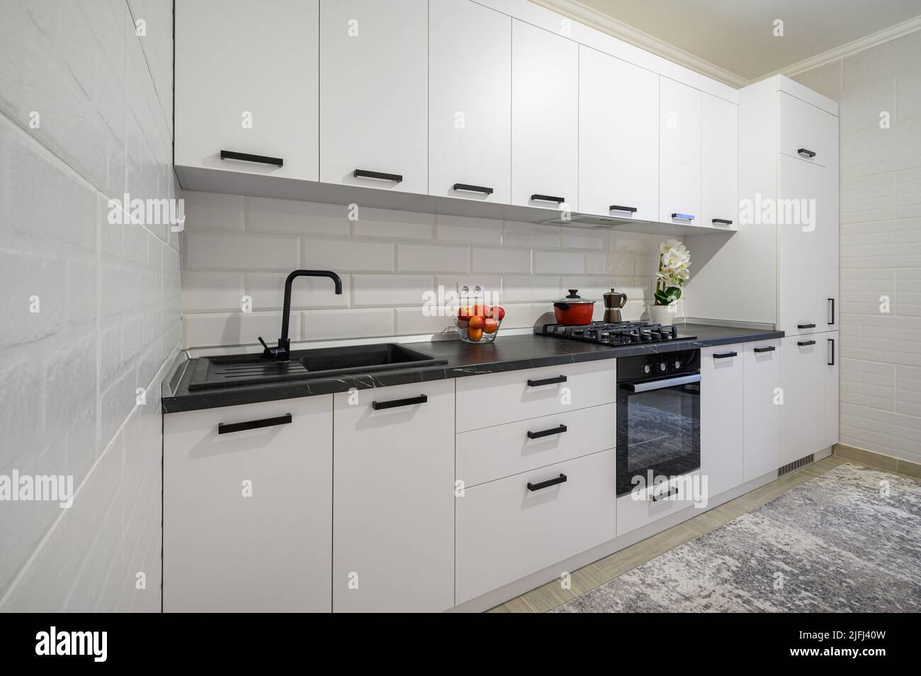 Trendy white modern kitchen interior with minimalistic furniture Stock Photo