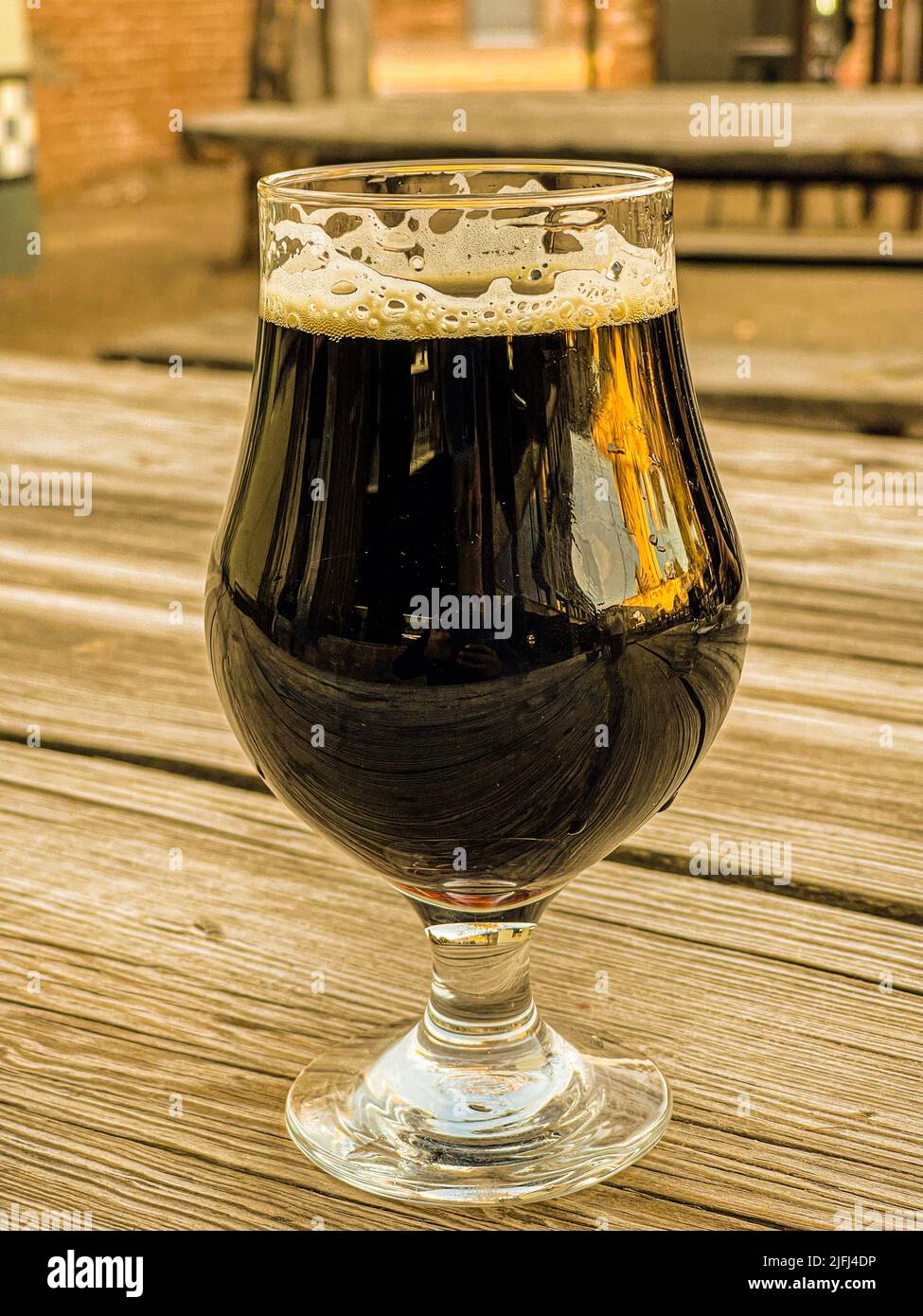 glass cup with craft beer from Cerveceria la Ruina dark, brown