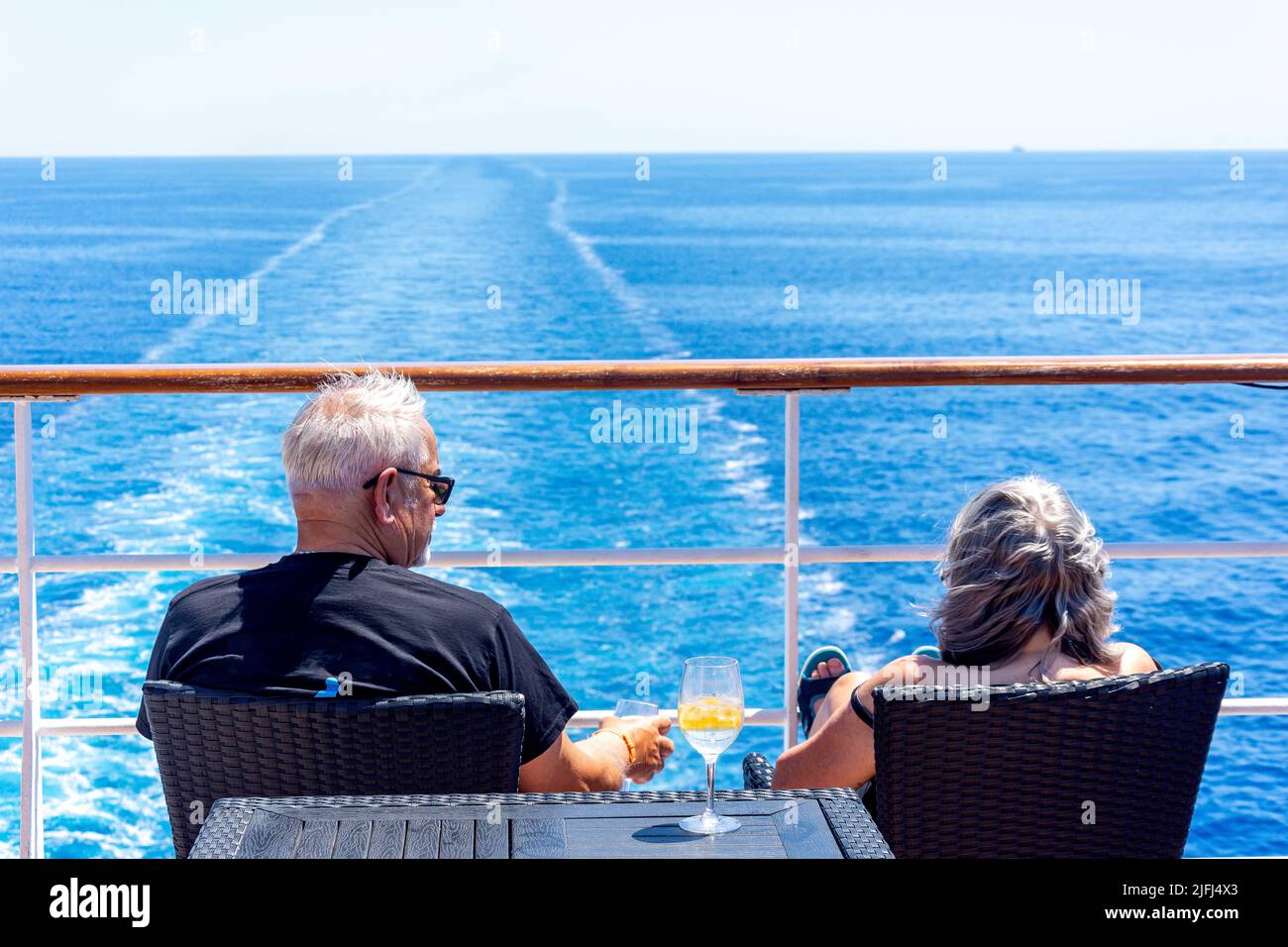 Couple relaxing at stern of Marella Explorer cruise ship, Adriatic Sea, Mediterranean Sea, Europe Stock Photo
