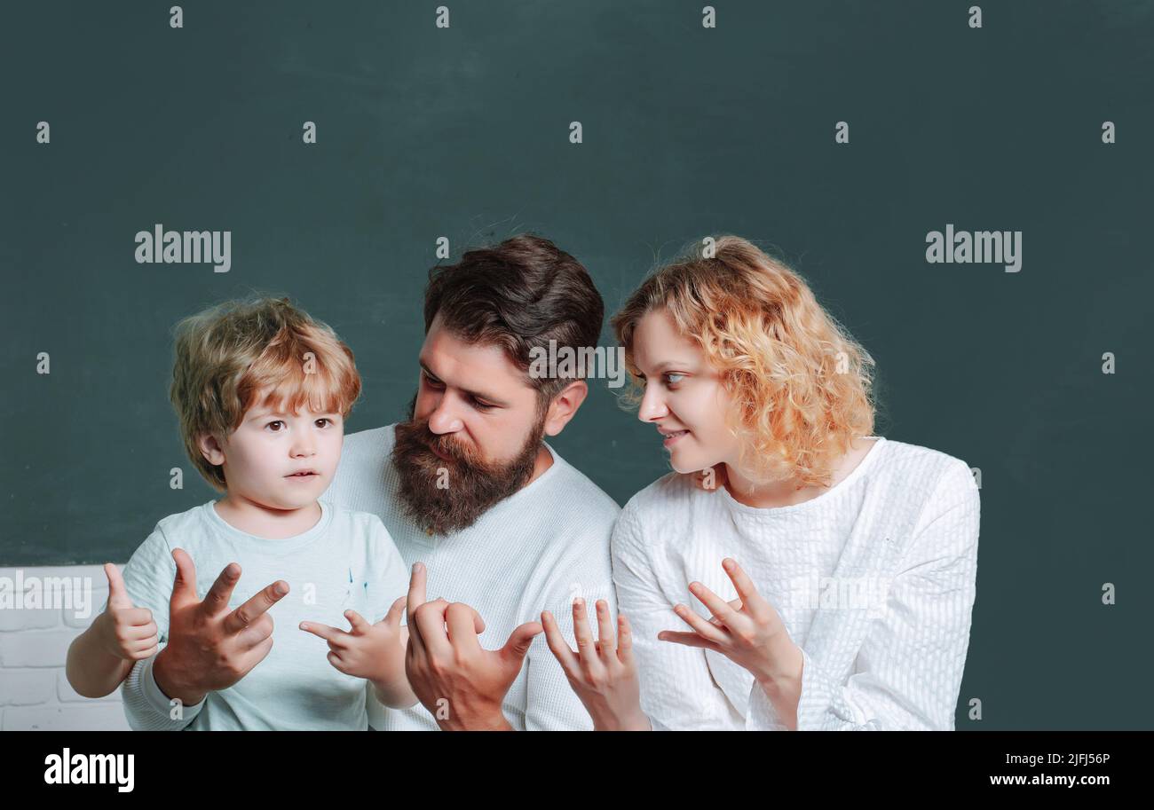 Woman and man helps the child boy. Young happy family schooling math ...