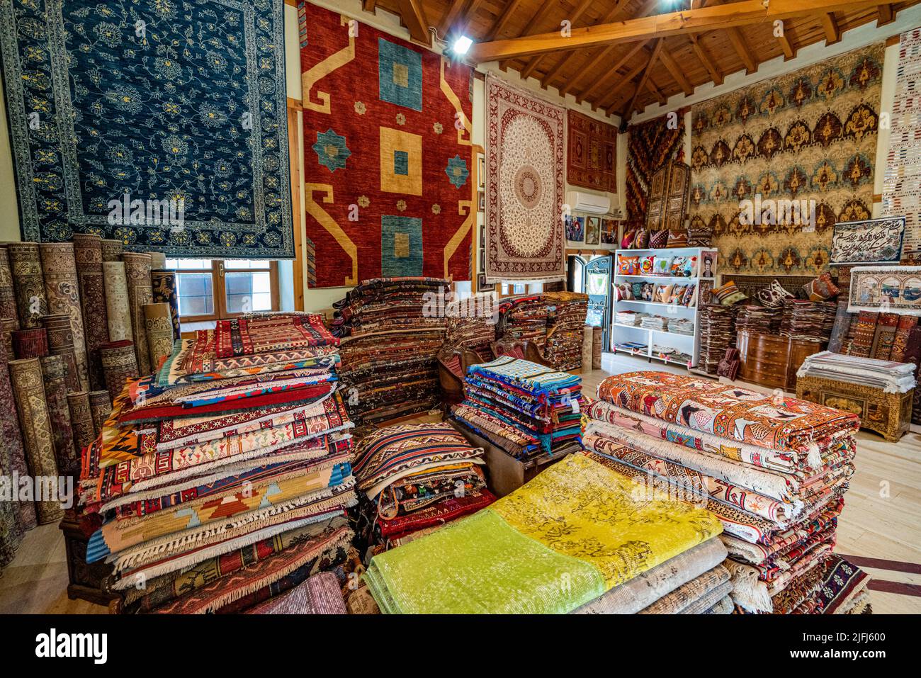 Large stacks of oriental  rugs in a store. Colorful carpet market. Turkey Stock Photo