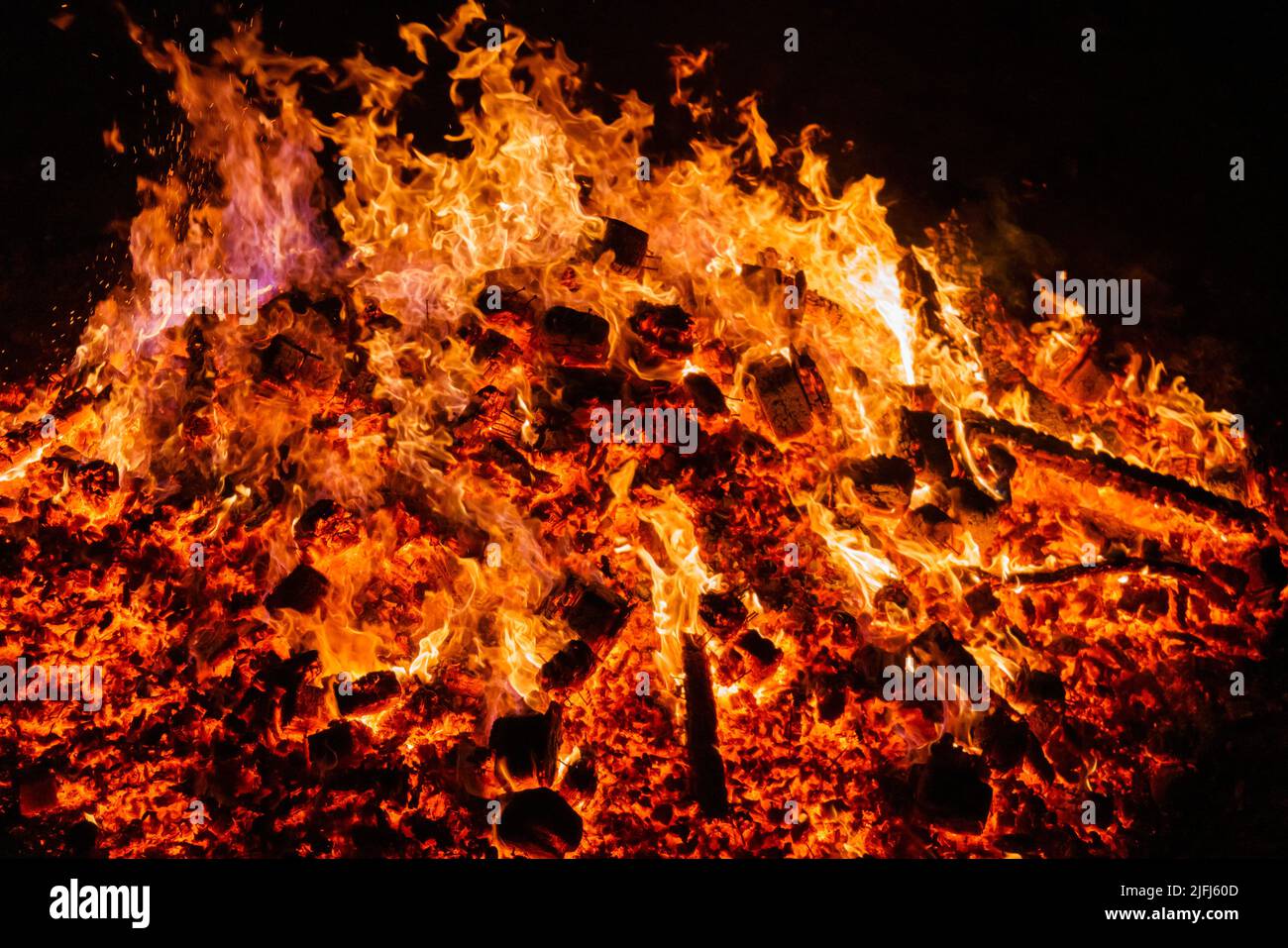 Burning coals from a fire abstract background. Stock Photo