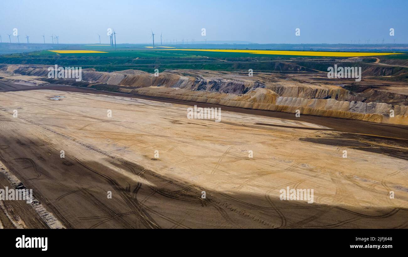 Panorama of Garzweiler surface mine in Germany with heavy machinery and power plant in the distance Stock Photo