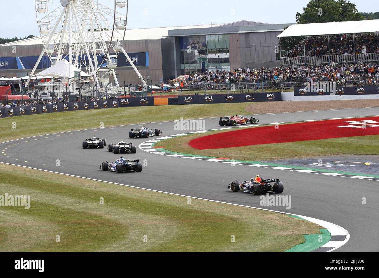 Silverstone, Northants, UK - 1st July, 2022 A stream of F1 cars race around the Brooklands Corner during the LENOVO FORMULA 1 British Grand Prix week Stock Photo