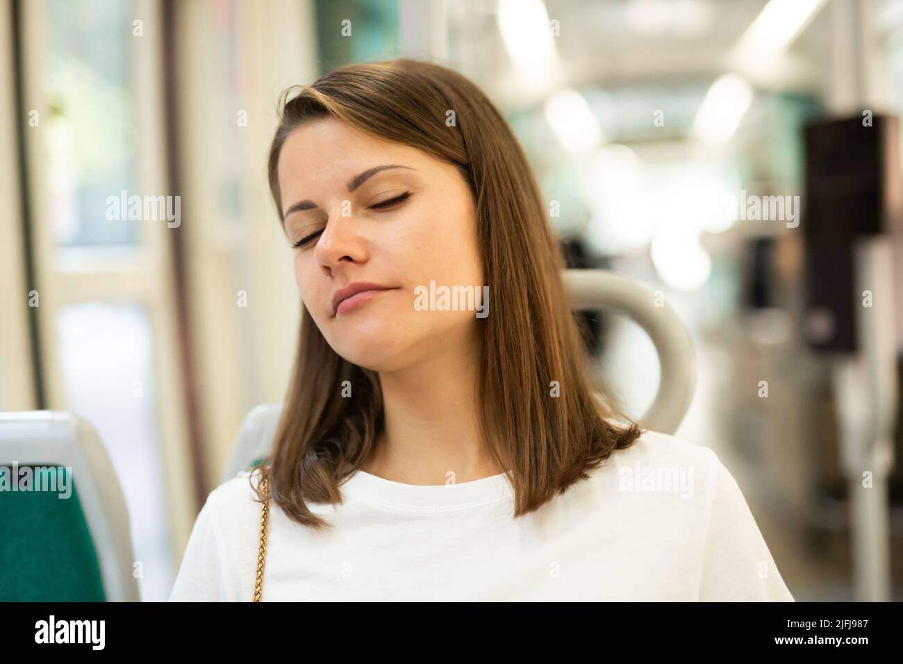 Woman sleeping in public transport Stock Photo Alamy