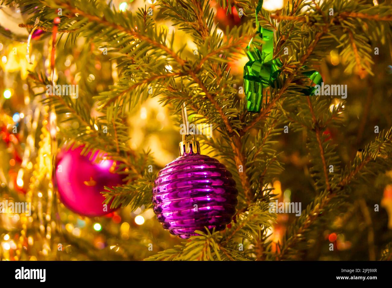 The holiday is a new year or Christmas, in the photo a live fir tree is decorated with toys, tinsel and beads. Retro. - Stock Image