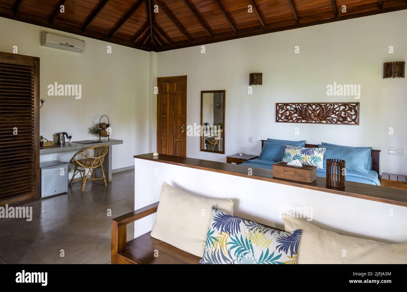 Tangalle, Sri Lanka - Nov 1, 2017: Hotel or home interior in Indian minimalist style. Inside residential house on tropical beach. Typical furniture wi Stock Photo