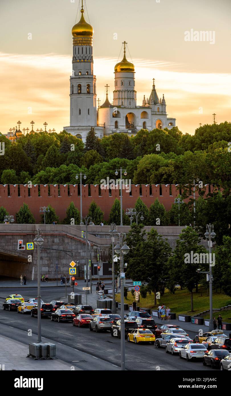 Moscow - Jun 28, 2022: Moscow Kremlin and car road at sunset, Russia. Vertical view of sunny old cathedrals and churches, tourist attractions of Mosco Stock Photo