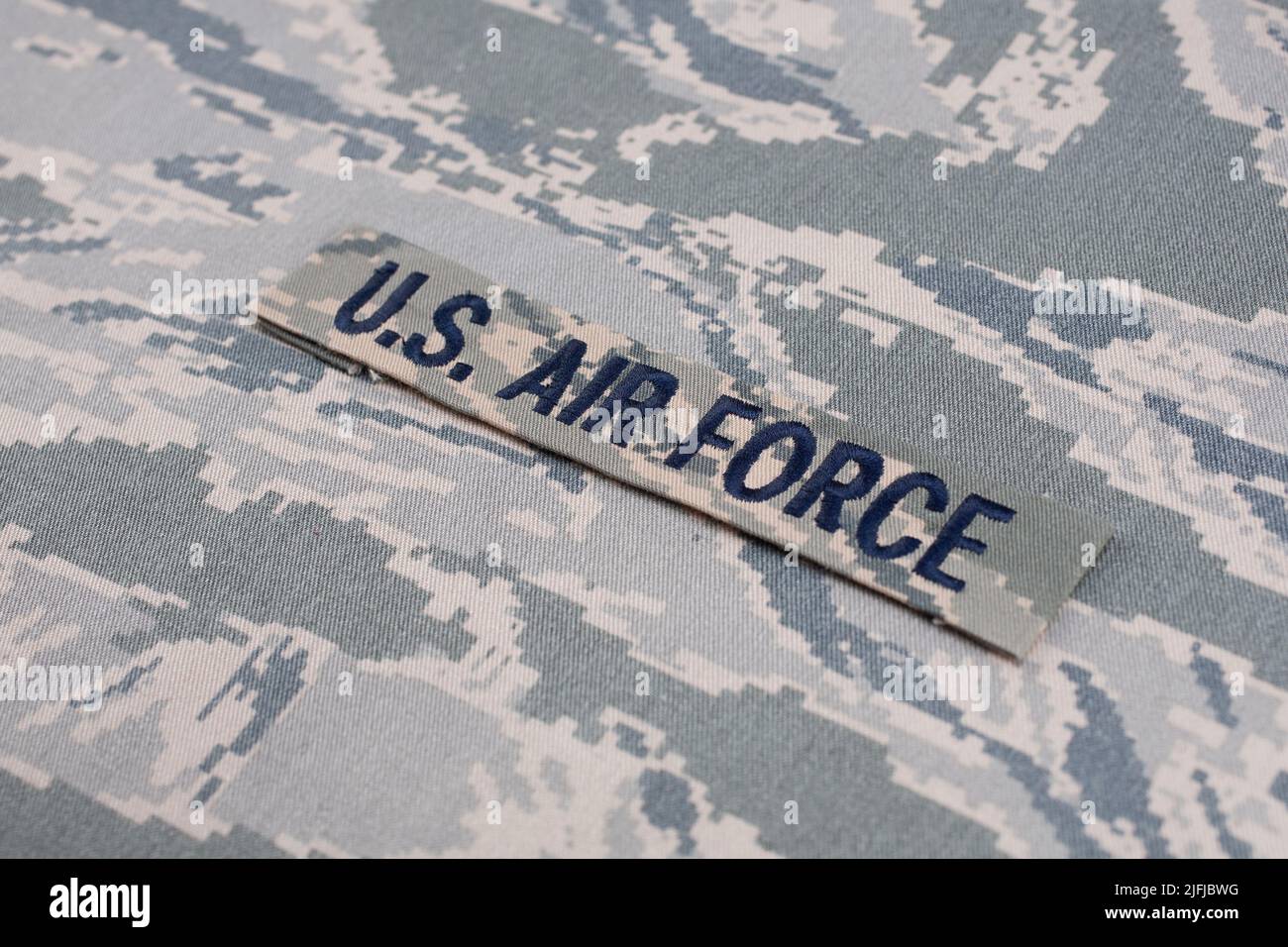 US AIR FORCE branch tape on digital tiger-stripe pattern Airman Battle Uniform (ABU) background Stock Photo