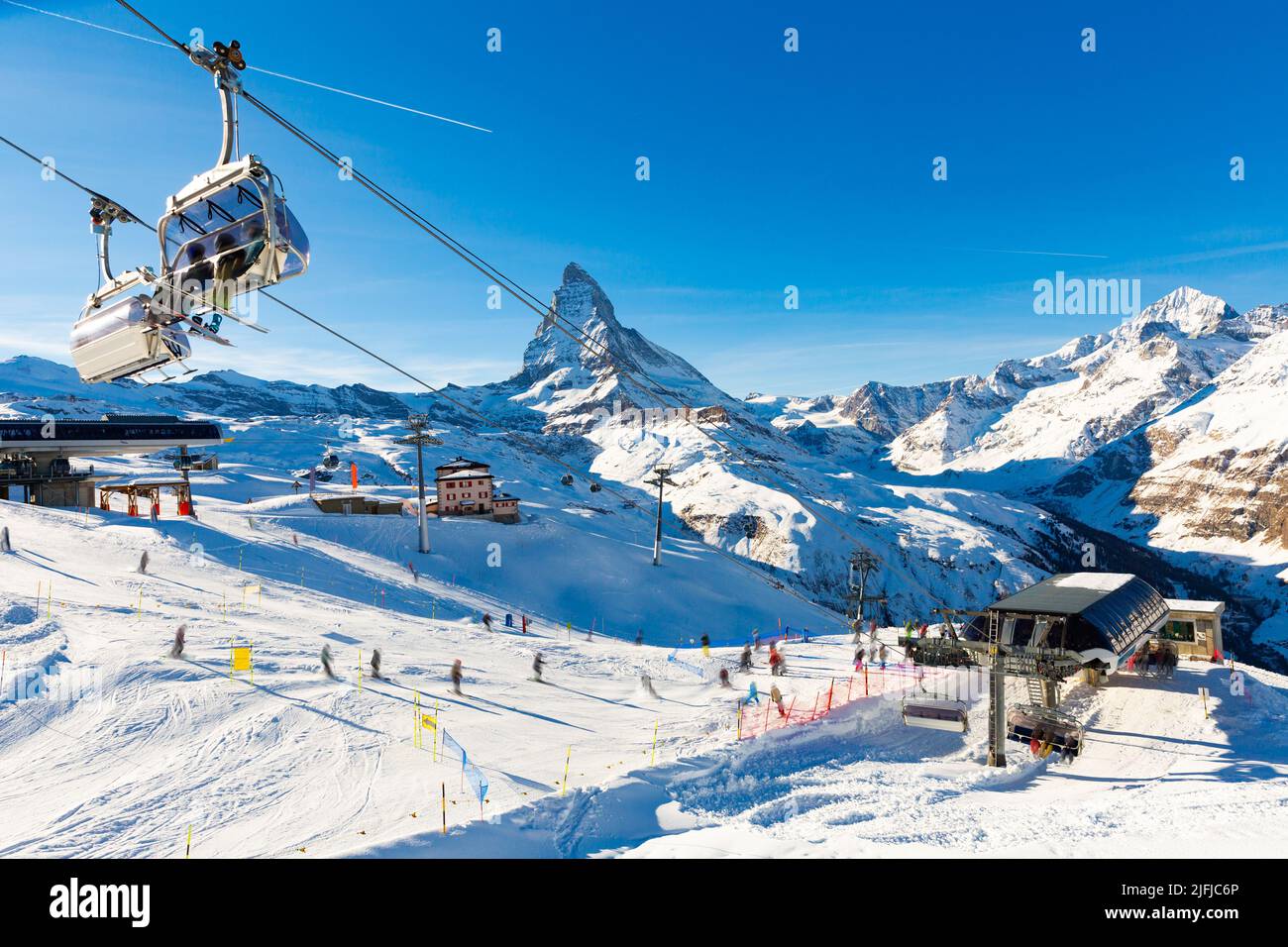 Alpine landscape with chairlift station of ski resort at foot of Matterhorn peak Stock Photo