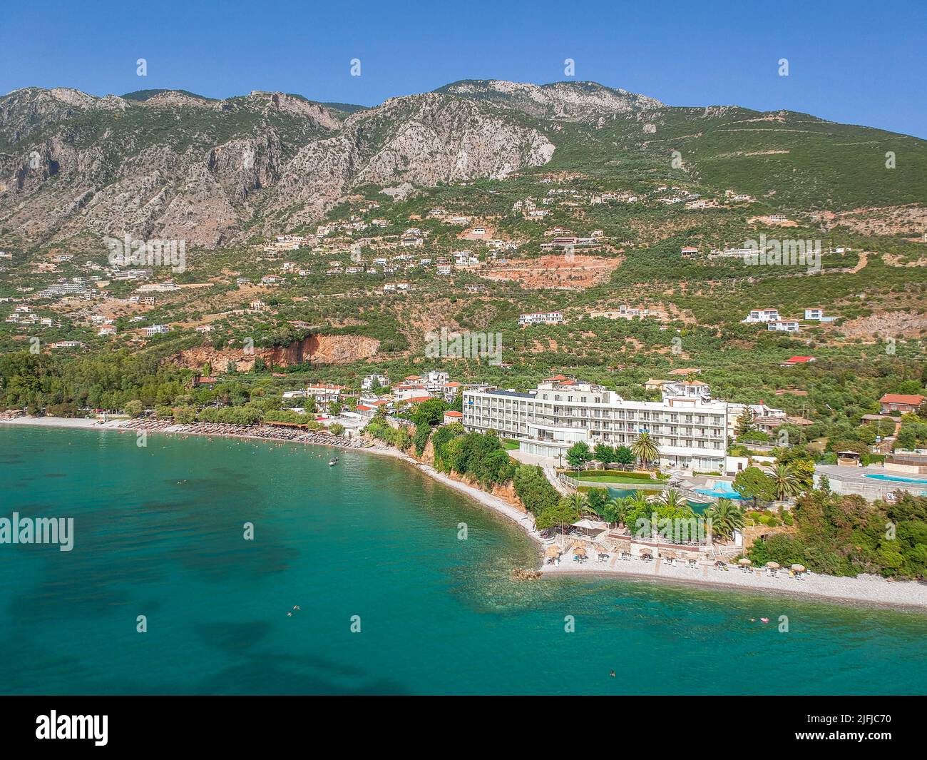 Tourists enjoy summer vacations swimming at Almyros beach in Kato verga seaside town near Kalamata, Greece. Stock Photo