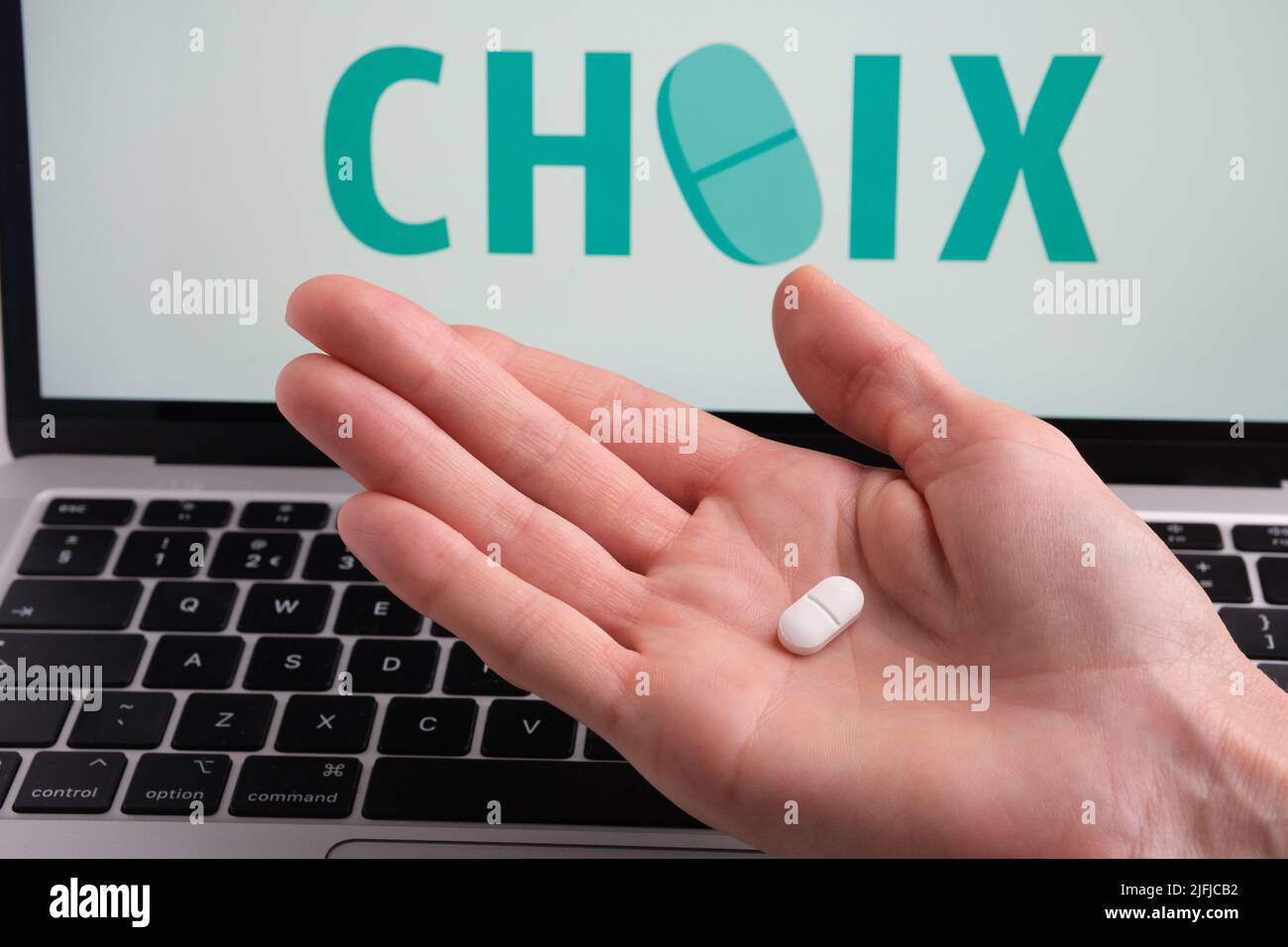 White pills and CHOIX company logo on a blurred background. Concept for online telehealth abortion platform. Stafford, United Kingdom, July 3, 2022 Stock Photo