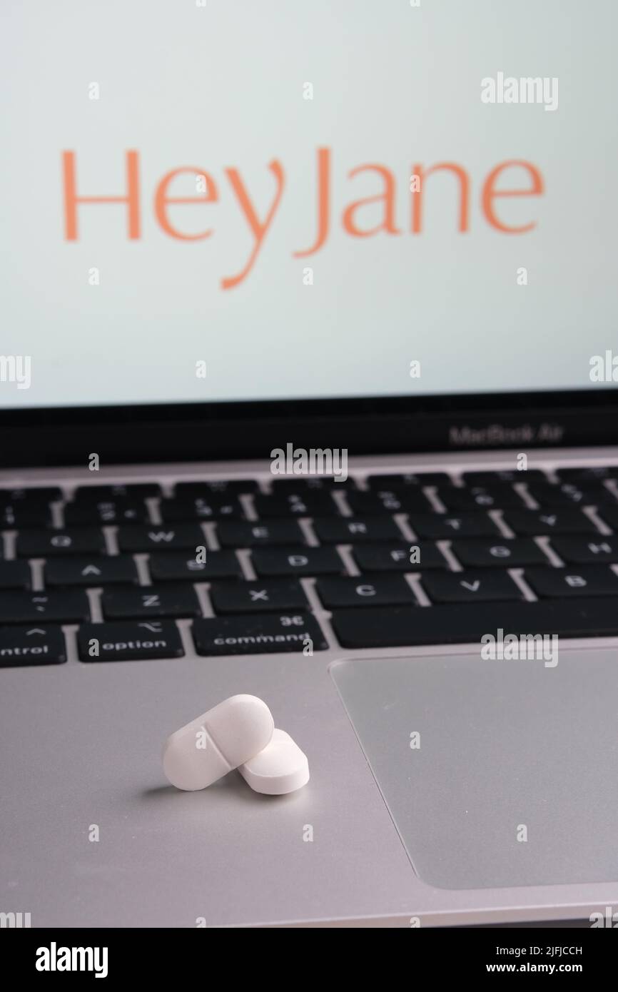 White pills and Hey Jane company logo on a blurred background. Concept for online telehealth abortion platform. Stafford, United Kingdom, July 3, 2022 Stock Photo