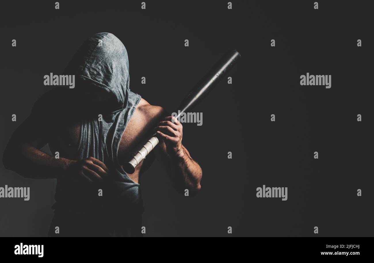 Dangerous man in the mask with baseball bat ready for fight. An