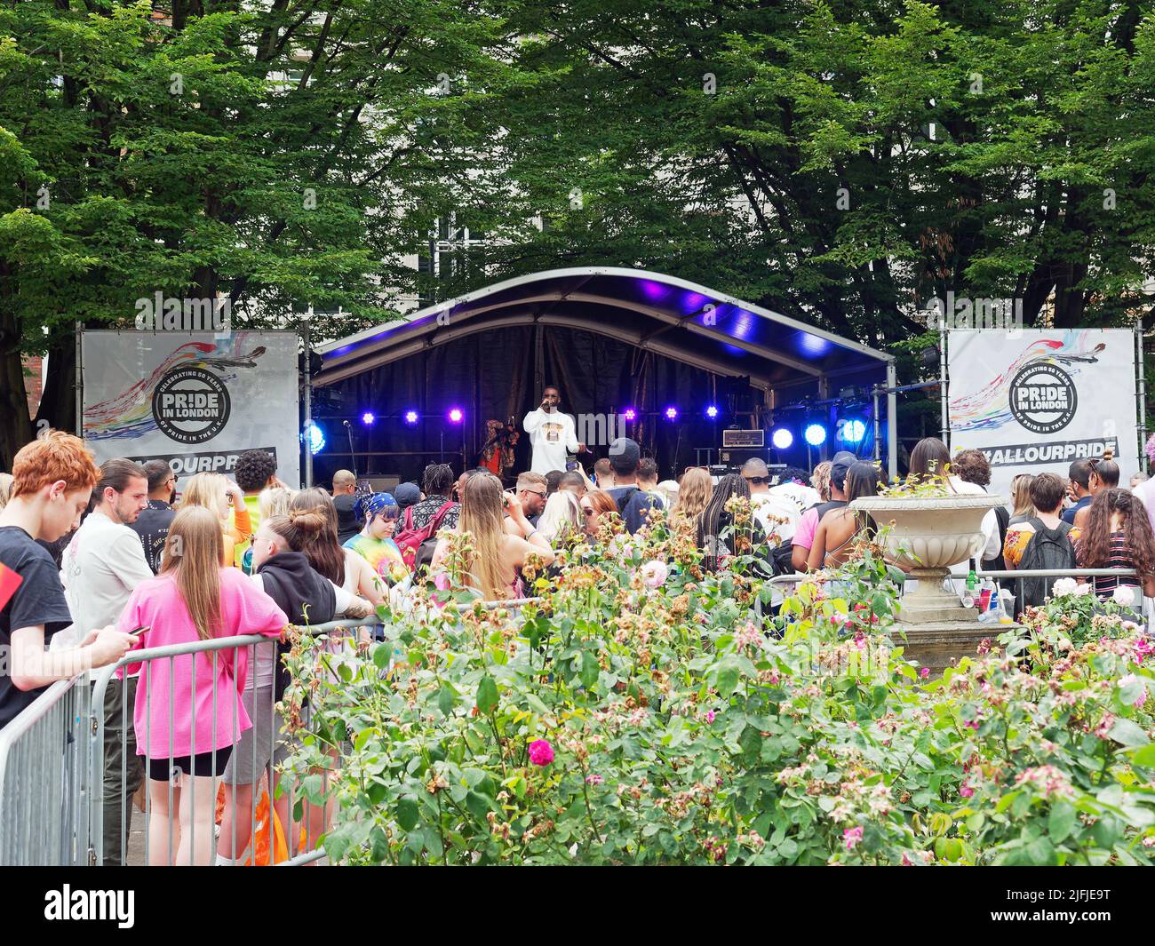 People enjoying a music event in Golden Square London during the Pride