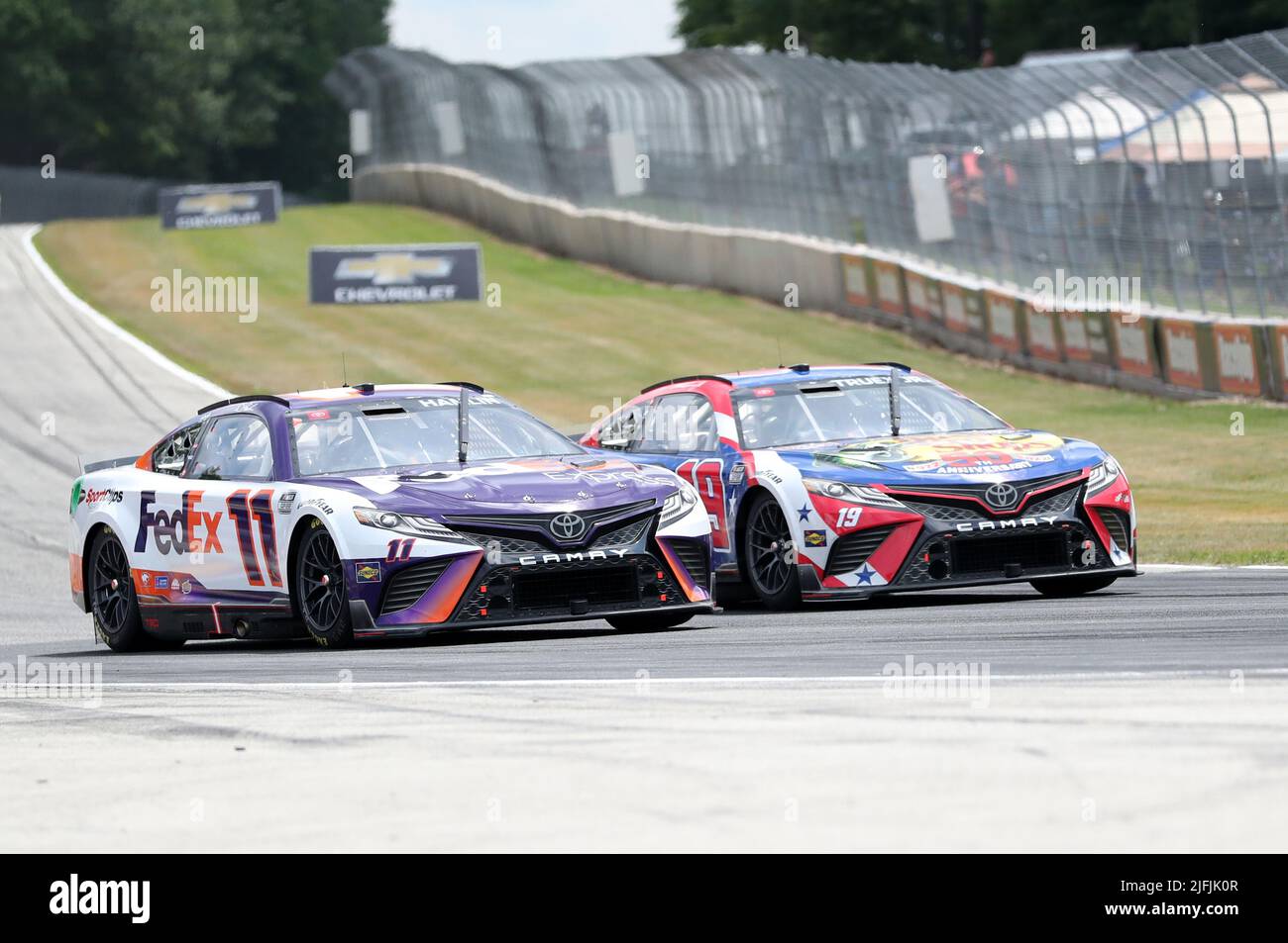 Plymouth, Wisconsin, USA. 3rd July, 2022. Denny Hamlin (11) and Martin Truex Jr (19) battle for position during the NASCAR Cup Series Kwik Trip 250 at Road America on July 03, 2022 in Plymouth, Wisconsin. Ricky Bassman/Cal Sport Media/Alamy Live News Stock Photo