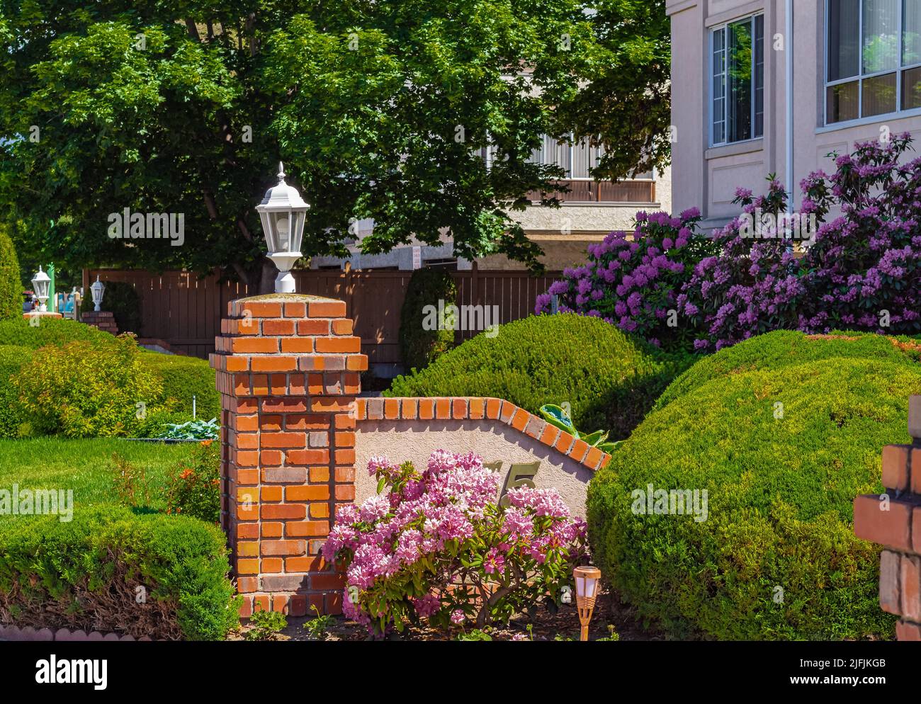 Entrance to a home through a beautiful garden with colorful flowers