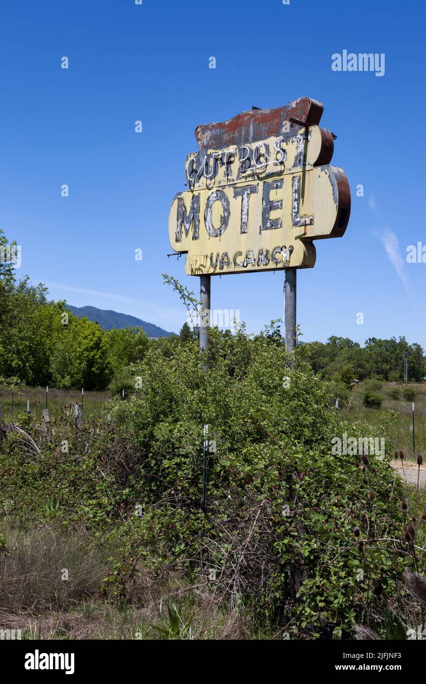 The weathered sign for the Outpost Motel along the Redwood Highway near Laytonville, California Stock Photo