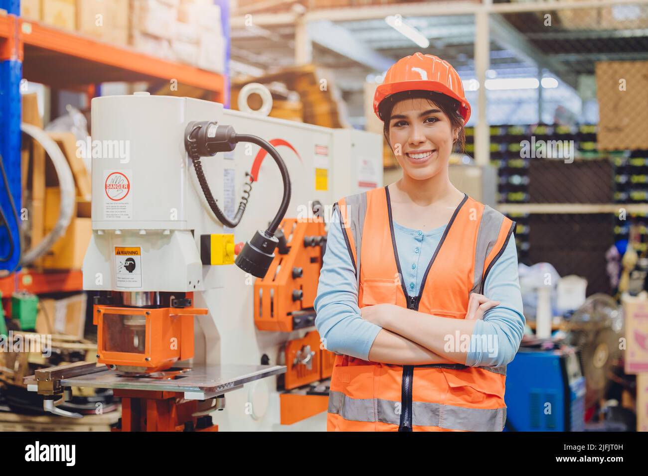 Portrait young teen Asian woman machine engineer working in heavy industry happy smiling confident. Stock Photo