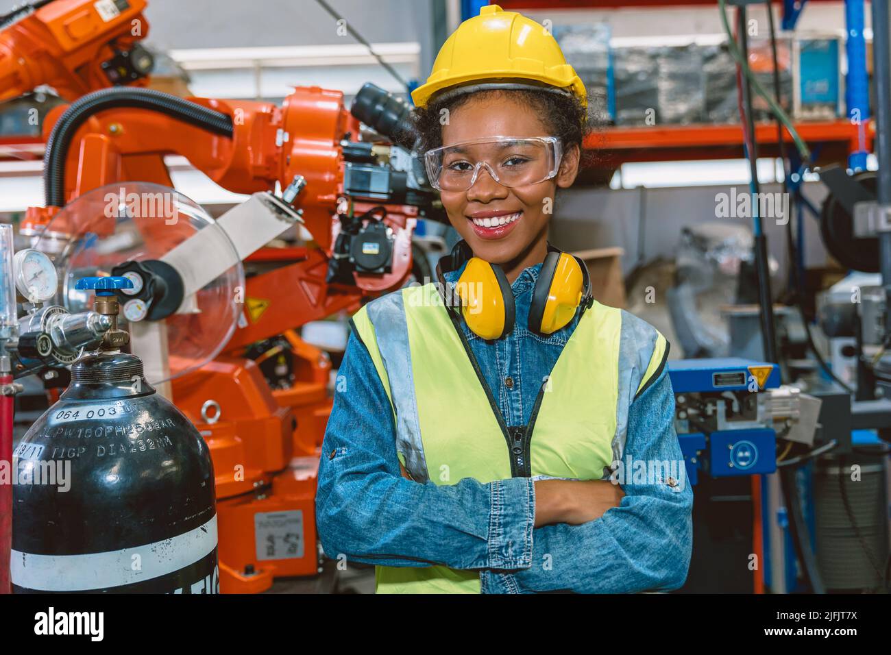 Portrait smart woman worker Black African teen girl happy smiling in modern factory Stock Photo