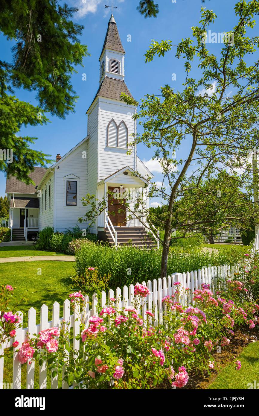 Exterior of a Little White Country Church on a Sunny Day and blue sky at the background. Beautiful traditional church in rural Canada-June 30,2022-Lan Stock Photo