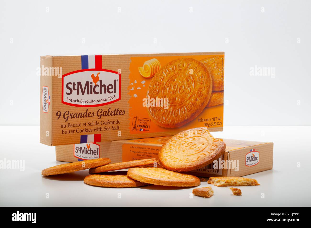 Prague, Czech Republic - 22, March  2022:Two packets of StMichel biscuits with Sea Salt on the white table. On the wood table of cookies stacked next Stock Photo