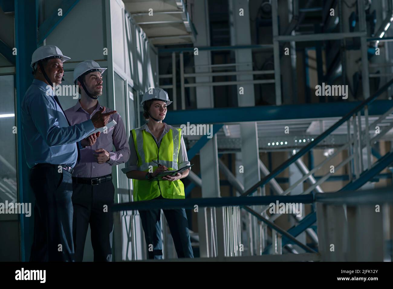 Team of architects working in the factory Stock Photo