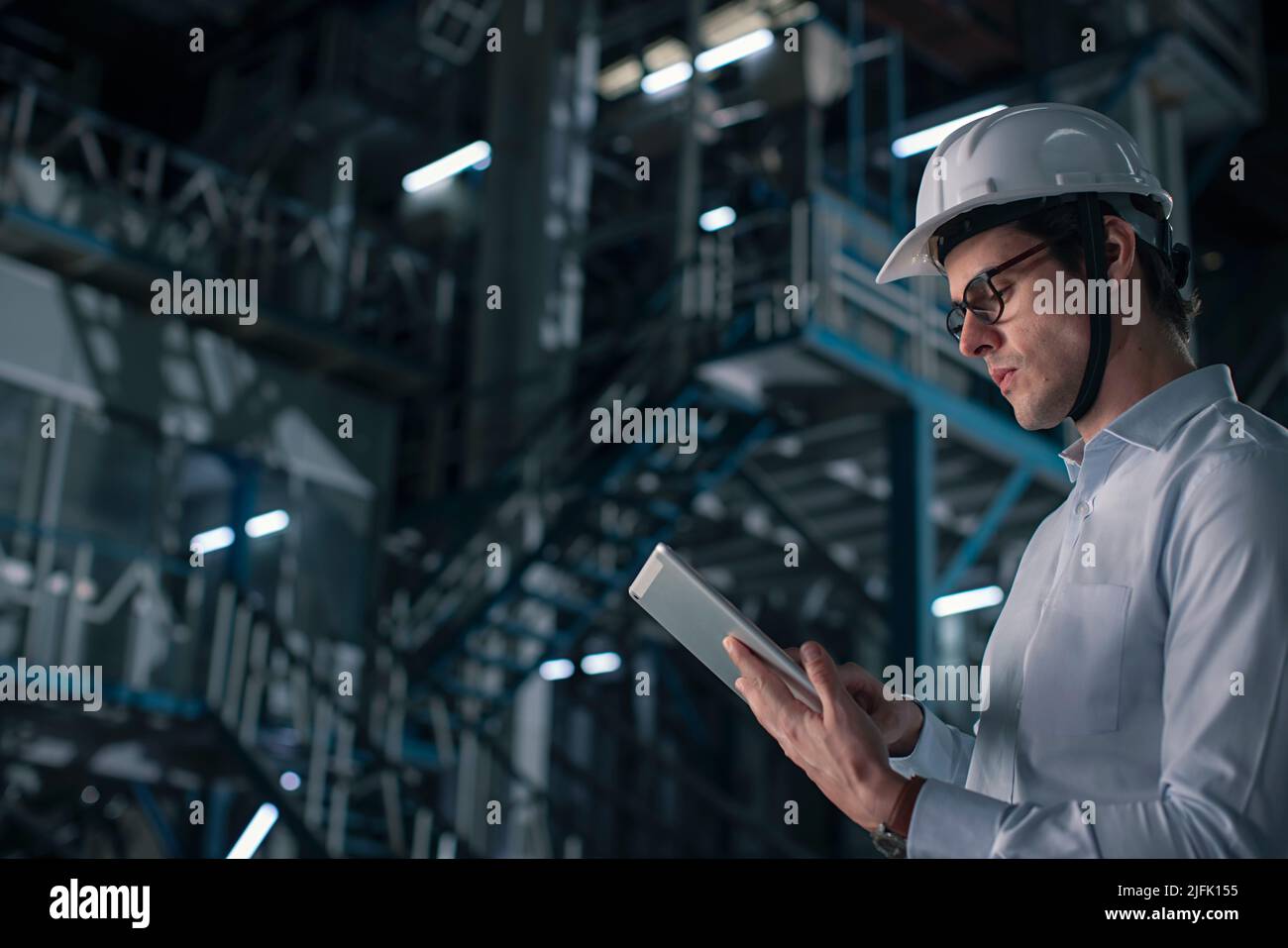 Mid adult man working on digital tablet in the factory Stock Photo
